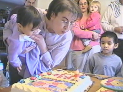 Mia and Mom with cake at party