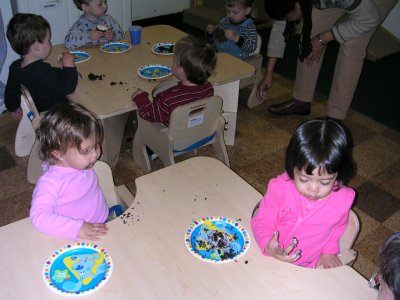 Mia at day-care trying to eat her cupcake