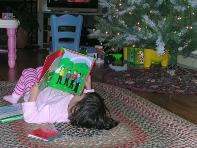 Mia reading the Wiggles by the Christmas Tree