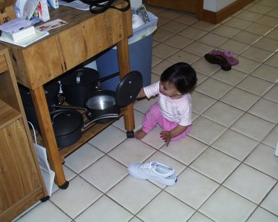 Mia playing with pots and pans