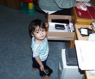 Mia standing and opening our desk drawer