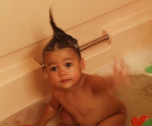 Mia in the tub with her hair scooped up