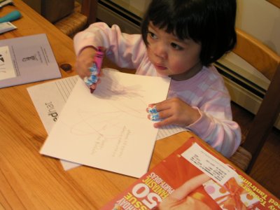 Mia signing a birthday card