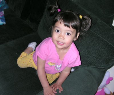 Mia with ponytails on the couch