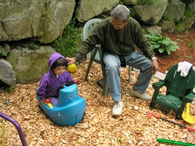 Mia with Grand Dad in her play yard boat