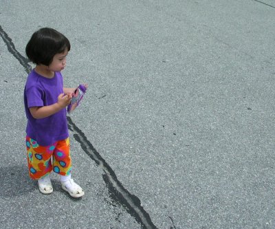 Mia in a parking lot with party pants