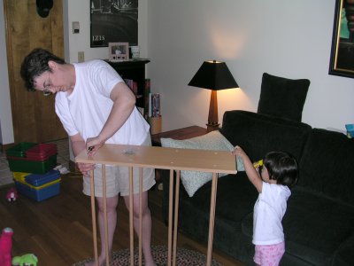 Mia helping Mom put together shelves