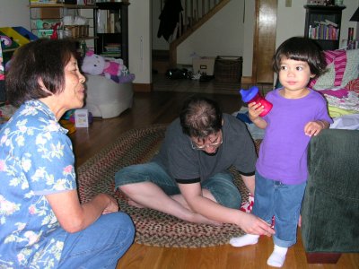 Mia trying on a pair of jeans (with Grandmom and Mom)