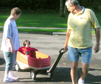 Mia getting a wagon ride with Larry and Jenn