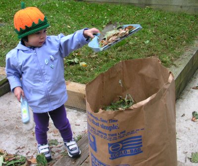 Mia in Halloween hat, helping with raking