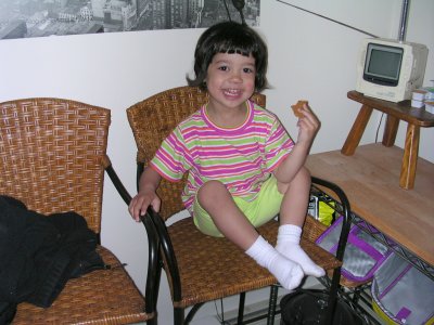 Mia on a high chair smiling