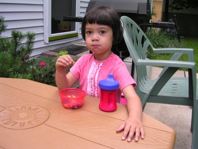 Mia eating snacks at her outdoor table