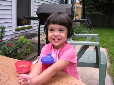 Mia smiling at her outdoor table