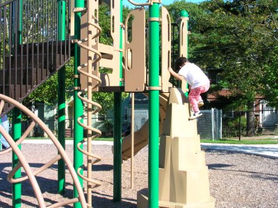 Mia climbing up the 'mountain' in the playground