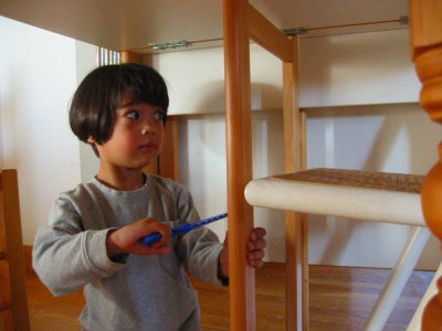 Mia fixing the table with her saw