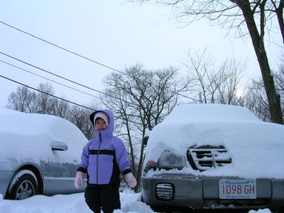 Mia outside in the snow near our cars