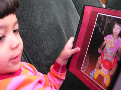Mia seeing herself in a photo album