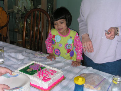 Mia in front of her birthday cake at Uncle Mark's