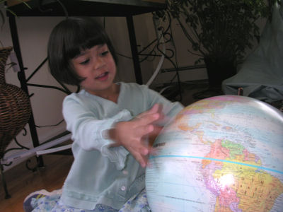 Mia with a globe