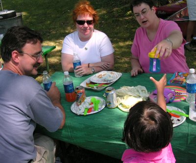 Mia at table with Uncle Mike, Aunt Cherie, and Mom