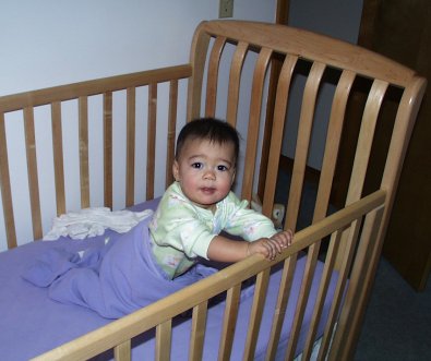 Mia pulling up in her crib