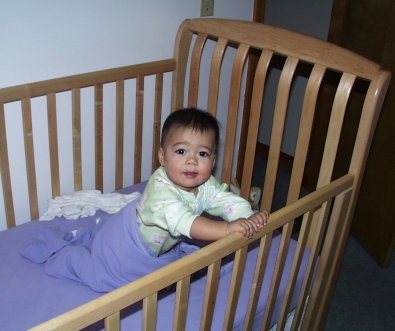 Mia pulling up in her crib