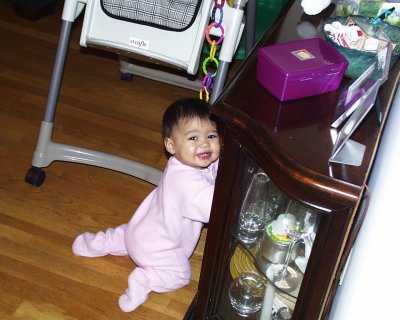 Mia at the cabinet smiling