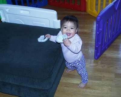 Mia laughing with her shoes by ottoman