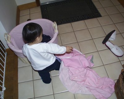 Mia tossing around laundry