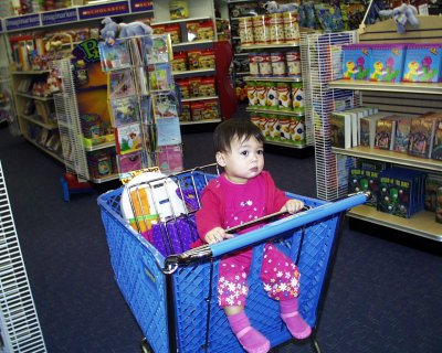 Mia in R' Us, in a shopping cart