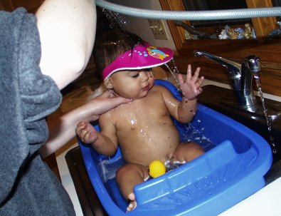 Mia taking bath with shampoo hat