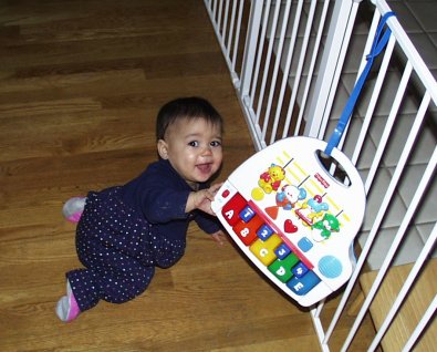 Mia reaching for the piano