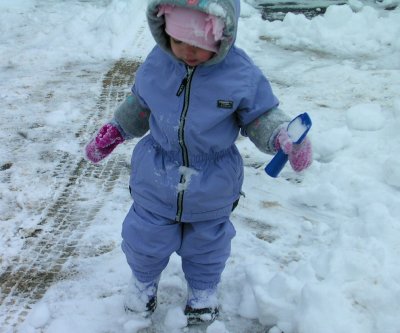 Mia in our cleared out drive-way with her little shovel